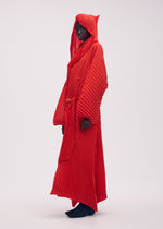 A model wears the ISSEY MIYAKE WAVE PLEATS coat.