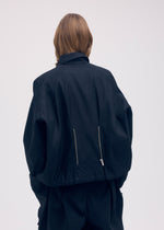 A model wears the ISSEY MIYAKE PEEKABOO jacket.