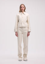 A model wears the ISSEY MIYAKE GYPSUM jacket.