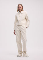 A model wears the ISSEY MIYAKE GYPSUM jacket.