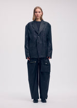 A model wears the ISSEY MIYAKE AERIAL STEEL clothing.