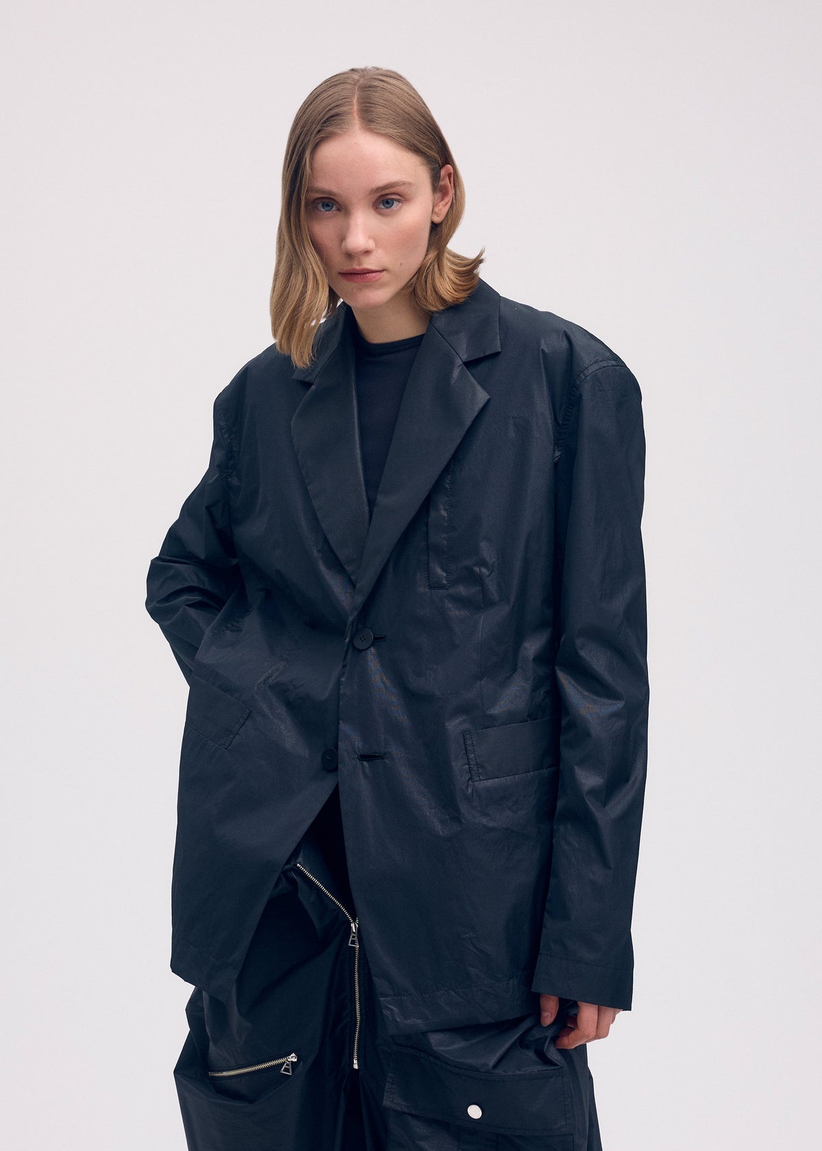 A model wears the ISSEY MIYAKE AERIAL STEEL clothing.
