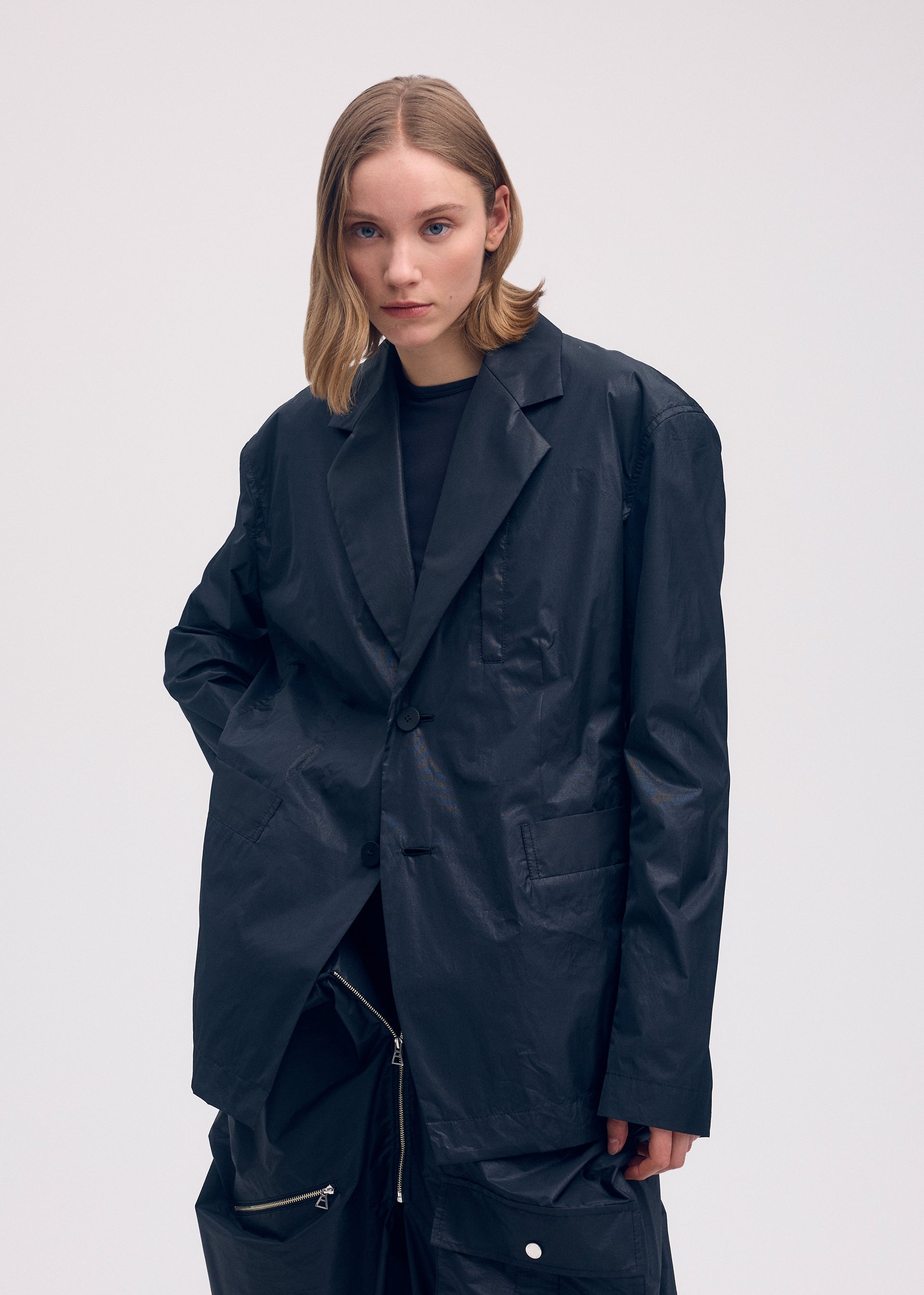 A model wears the ISSEY MIYAKE AERIAL STEEL clothing.