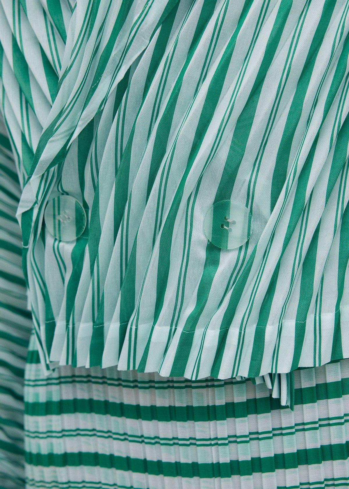 A model wears the ISSEY MIYAKE GENERIC STRIPES (HAND PLEATS) clothing.