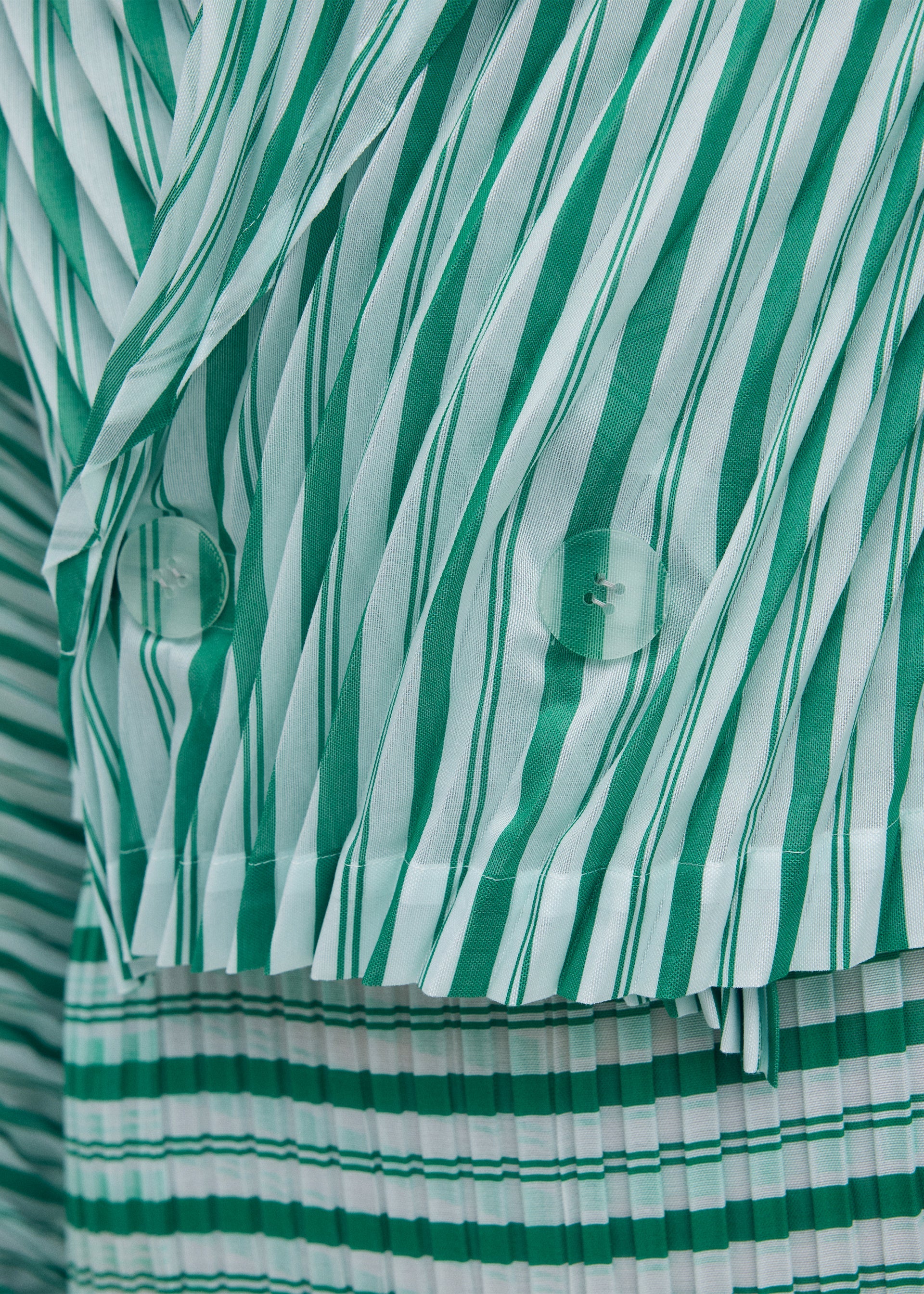 A model wears the ISSEY MIYAKE GENERIC STRIPES (HAND PLEATS) clothing.