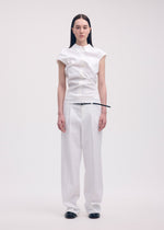 A model wears the ISSEY MIYAKE LIKE TORSO LIKE SHIRT trousers.