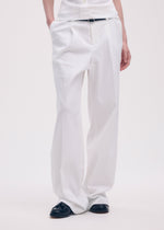 A model wears the ISSEY MIYAKE LIKE TORSO LIKE SHIRT trousers.