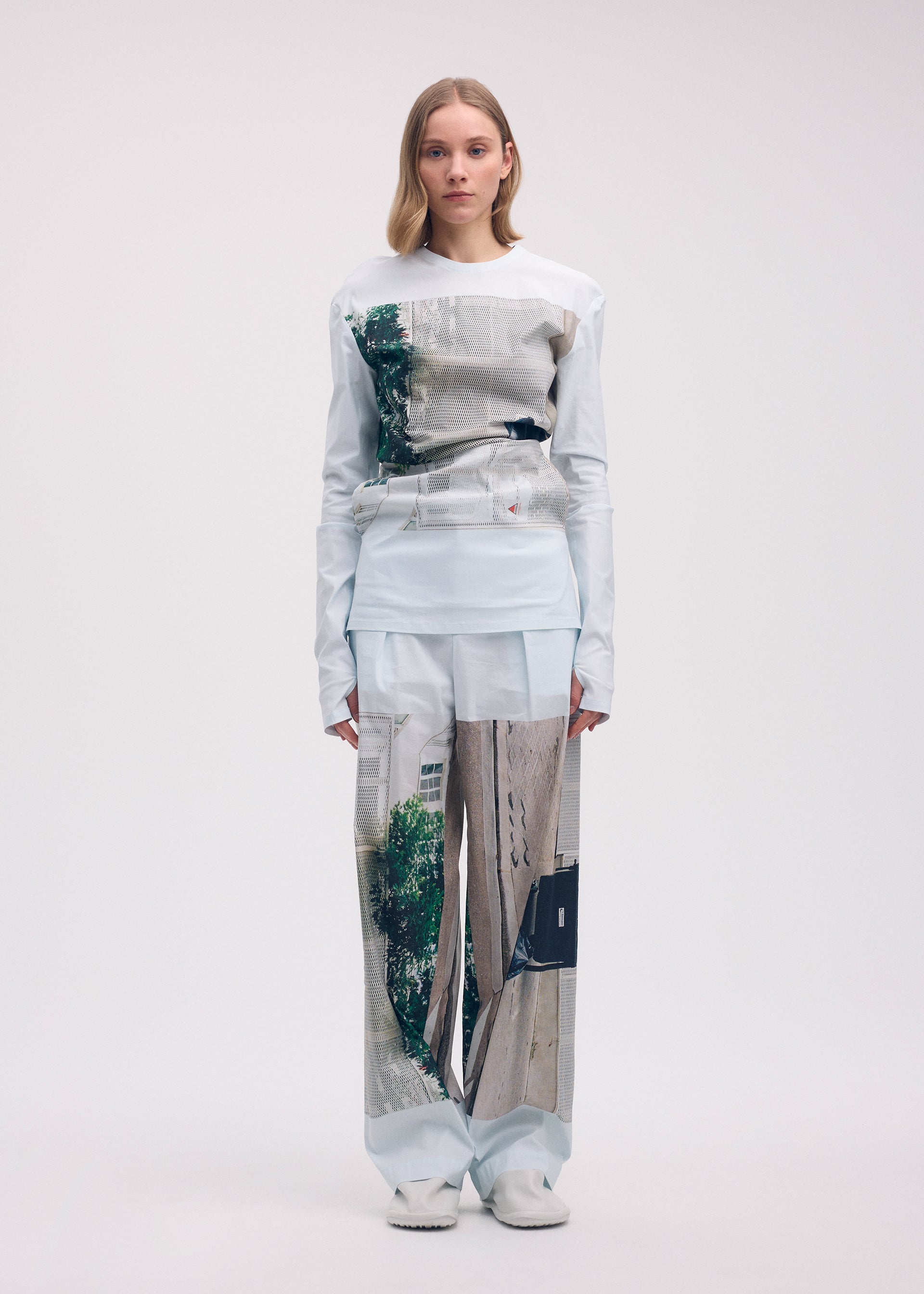 A model wears the ISSEY MIYAKE STREET VIEW trousers.