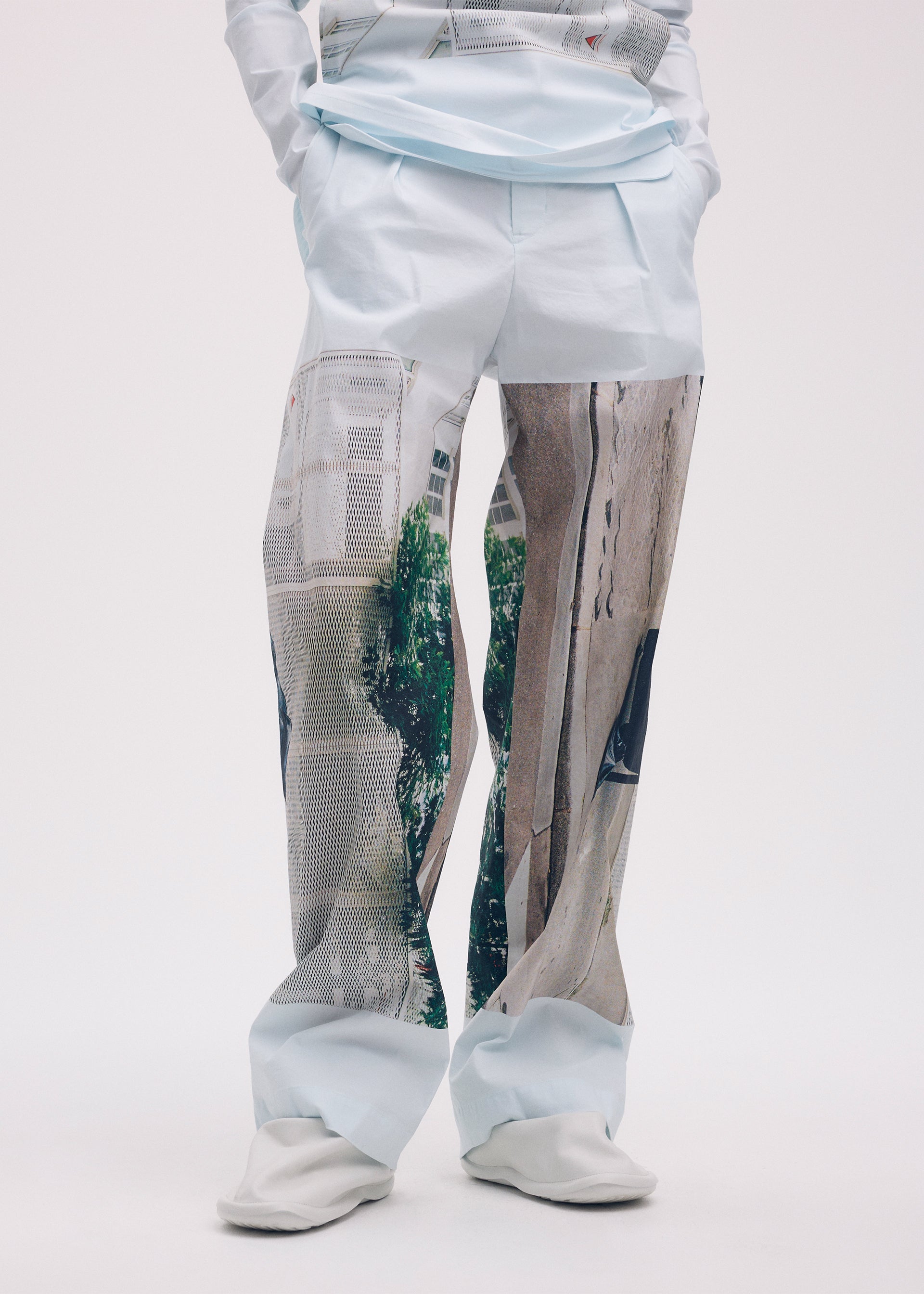 A model wears the ISSEY MIYAKE STREET VIEW trousers.