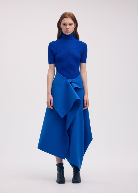 A model wears the ISSEY MIYAKE GYPSUM trousers.