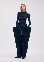 A model wears the ISSEY MIYAKE PEEKABOO trousers.