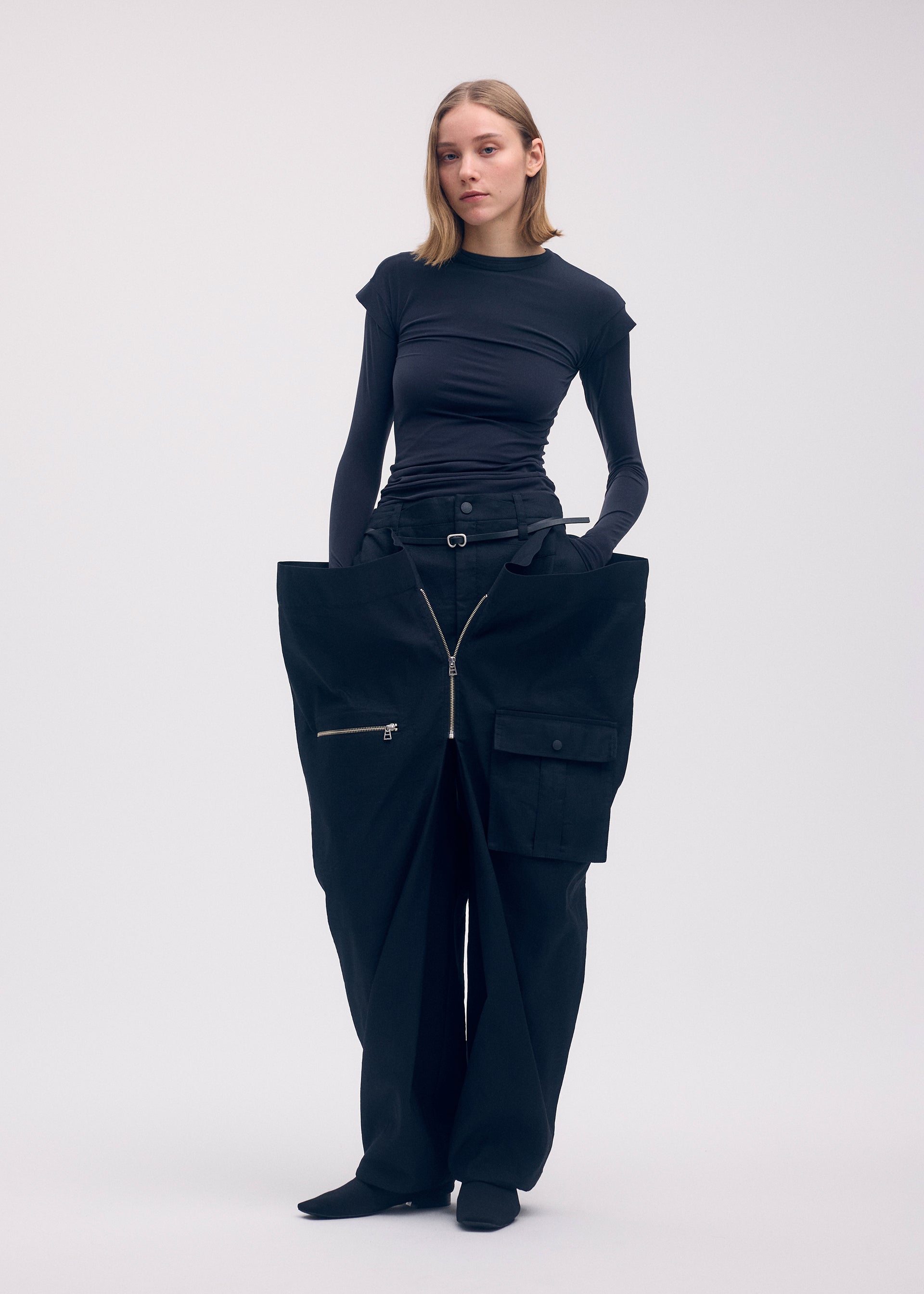 A model wears the ISSEY MIYAKE PEEKABOO trousers.