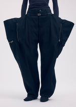 A model wears the ISSEY MIYAKE PEEKABOO trousers.