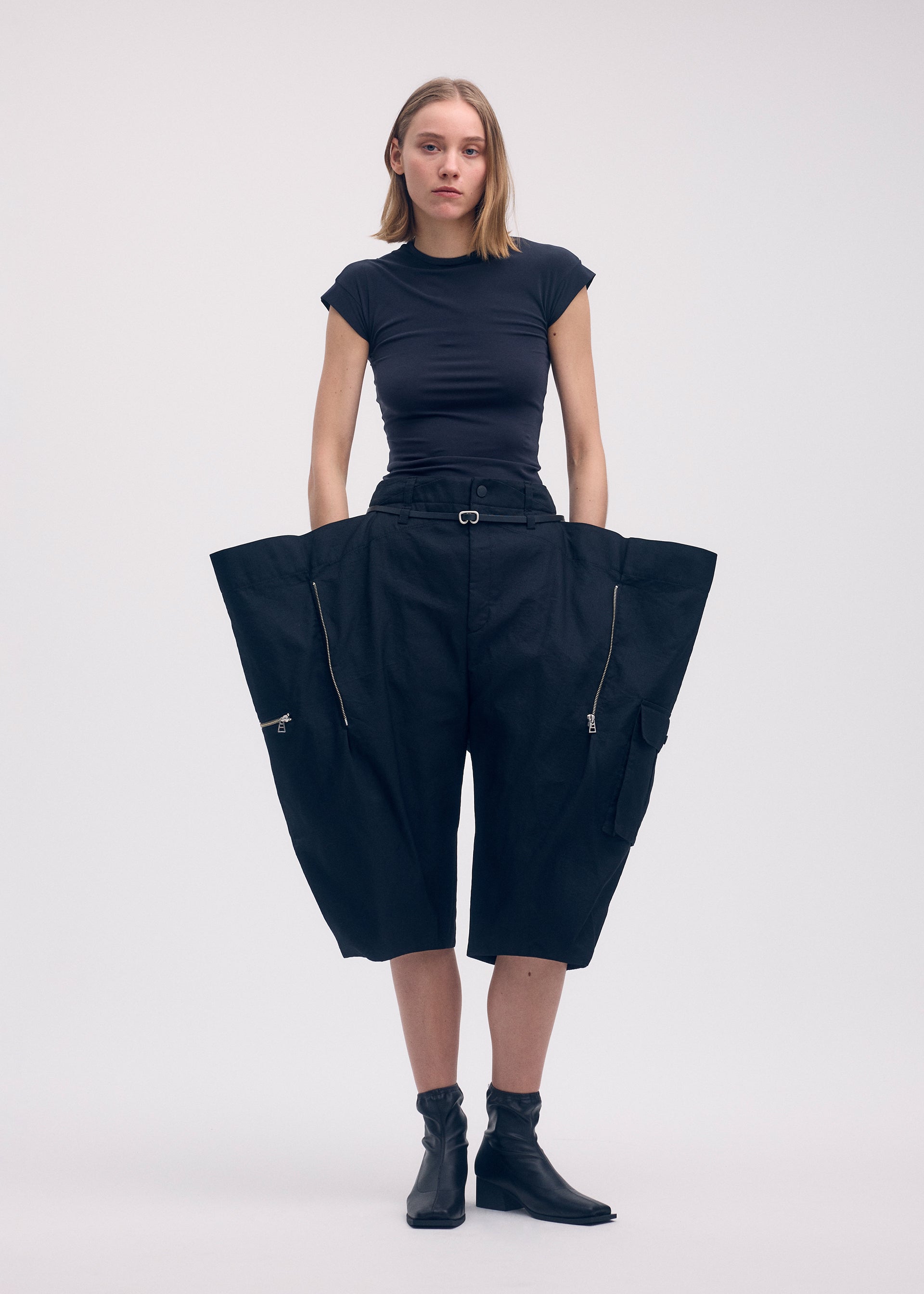 A model wears the ISSEY MIYAKE PEEKABOO trousers.