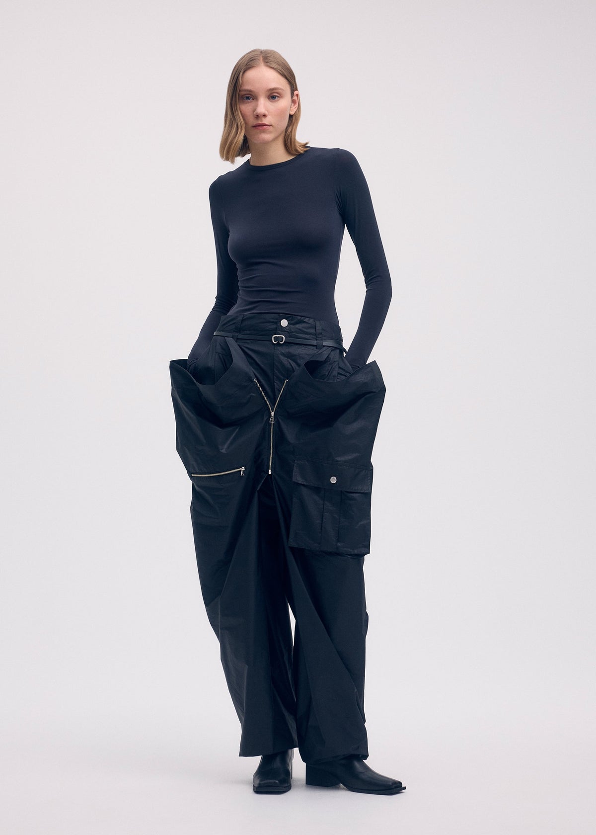 A model wears the ISSEY MIYAKE AERIAL STEEL clothing.