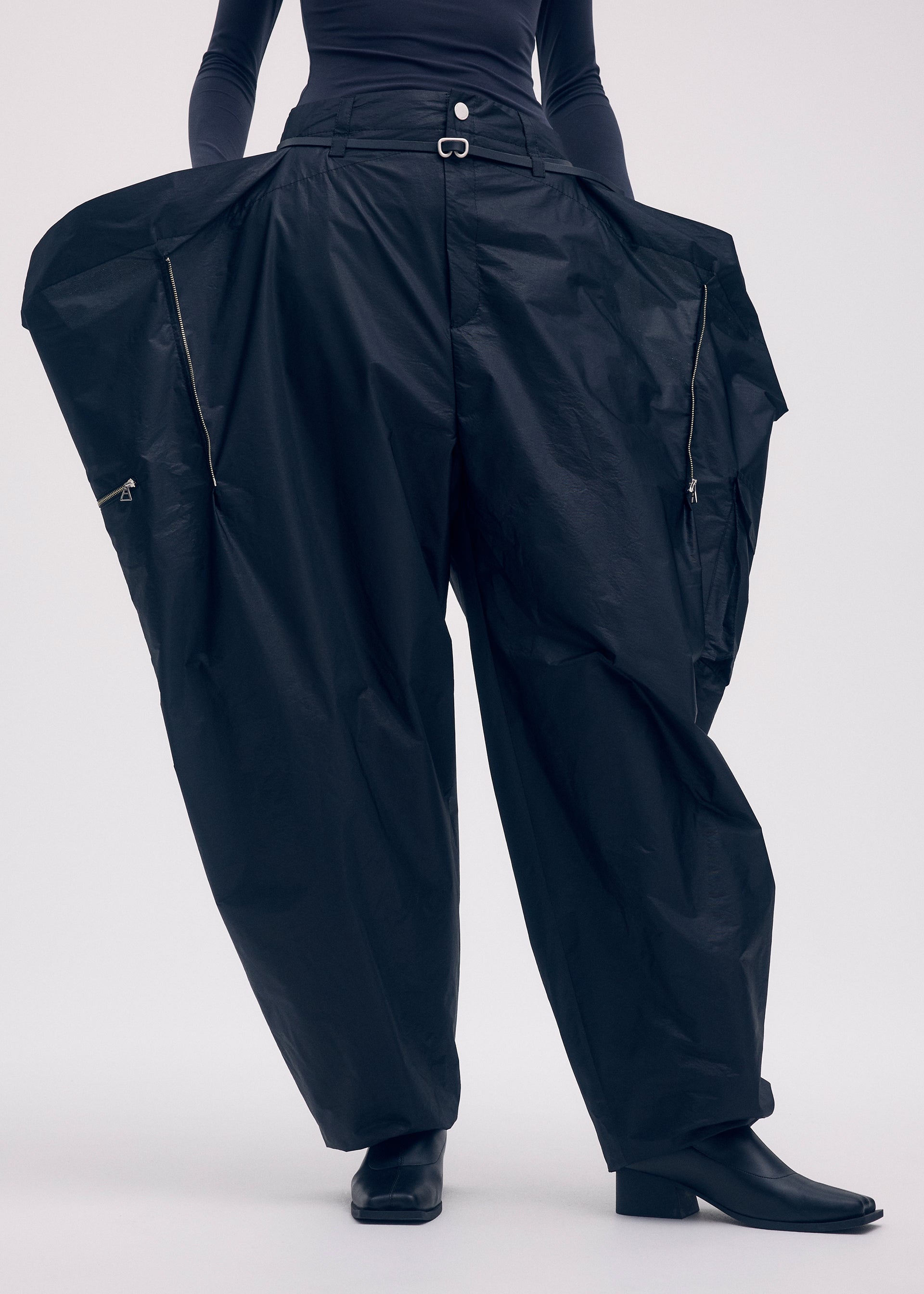 A model wears the ISSEY MIYAKE AERIAL STEEL clothing.