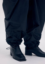 A model wears the ISSEY MIYAKE AERIAL STEEL clothing.