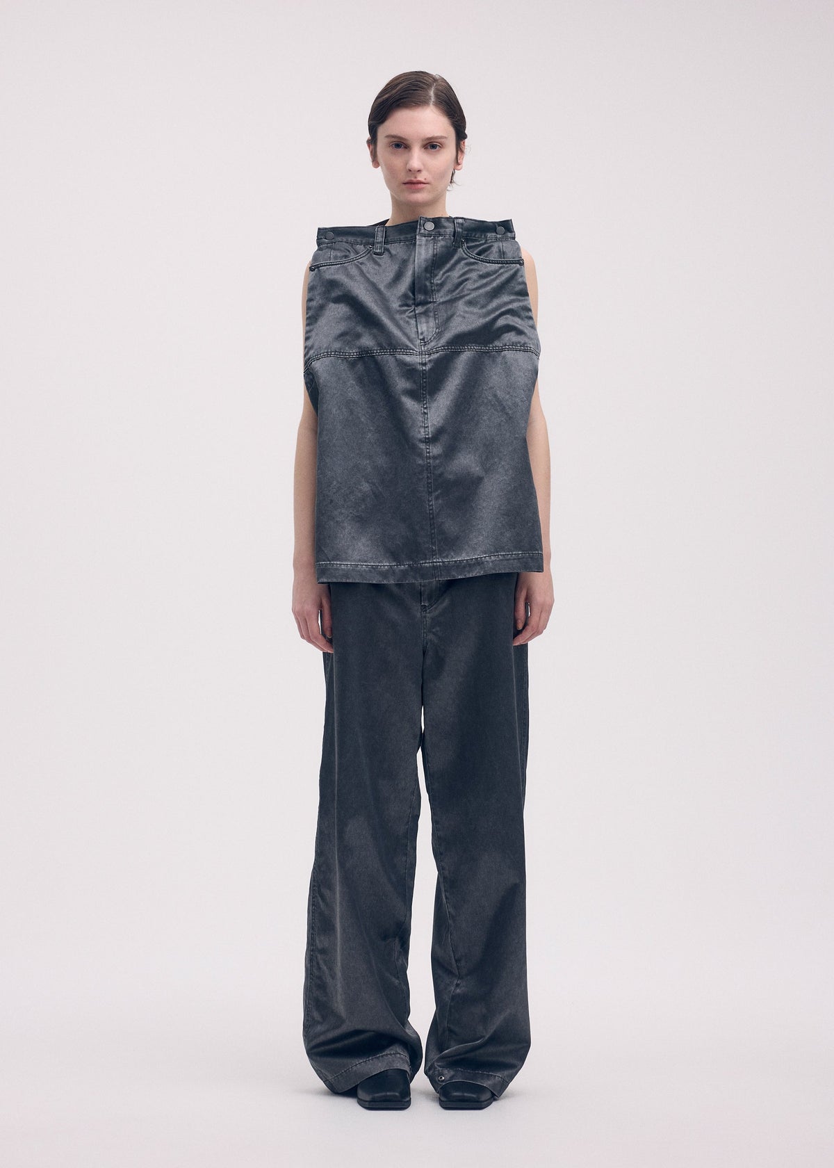 A model wears the ISSEY MIYAKE PSEUDO JEANS trousers.