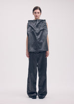 A model wears the ISSEY MIYAKE PSEUDO JEANS trousers.