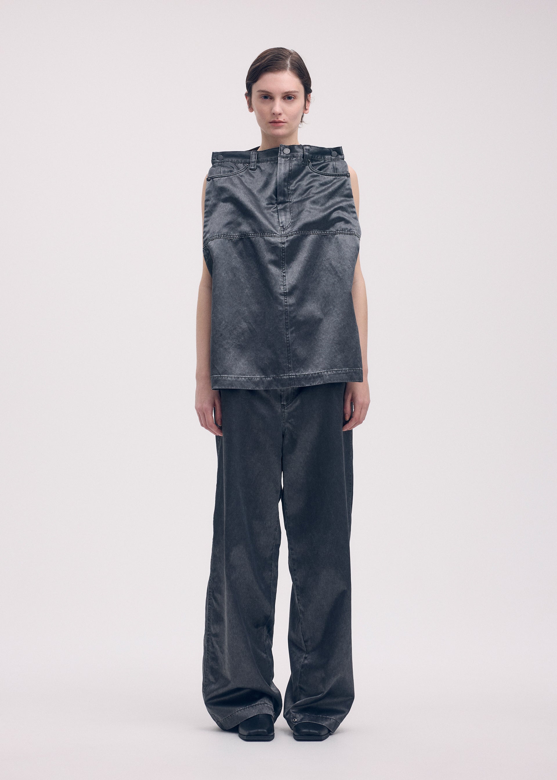 A model wears the ISSEY MIYAKE PSEUDO JEANS trousers.