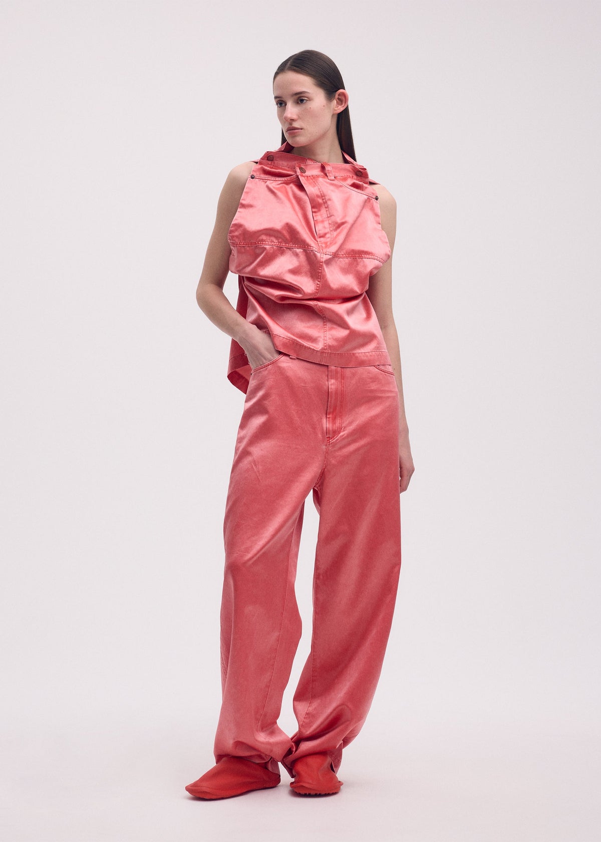 A model wears the ISSEY MIYAKE PSEUDO JEANS trousers.