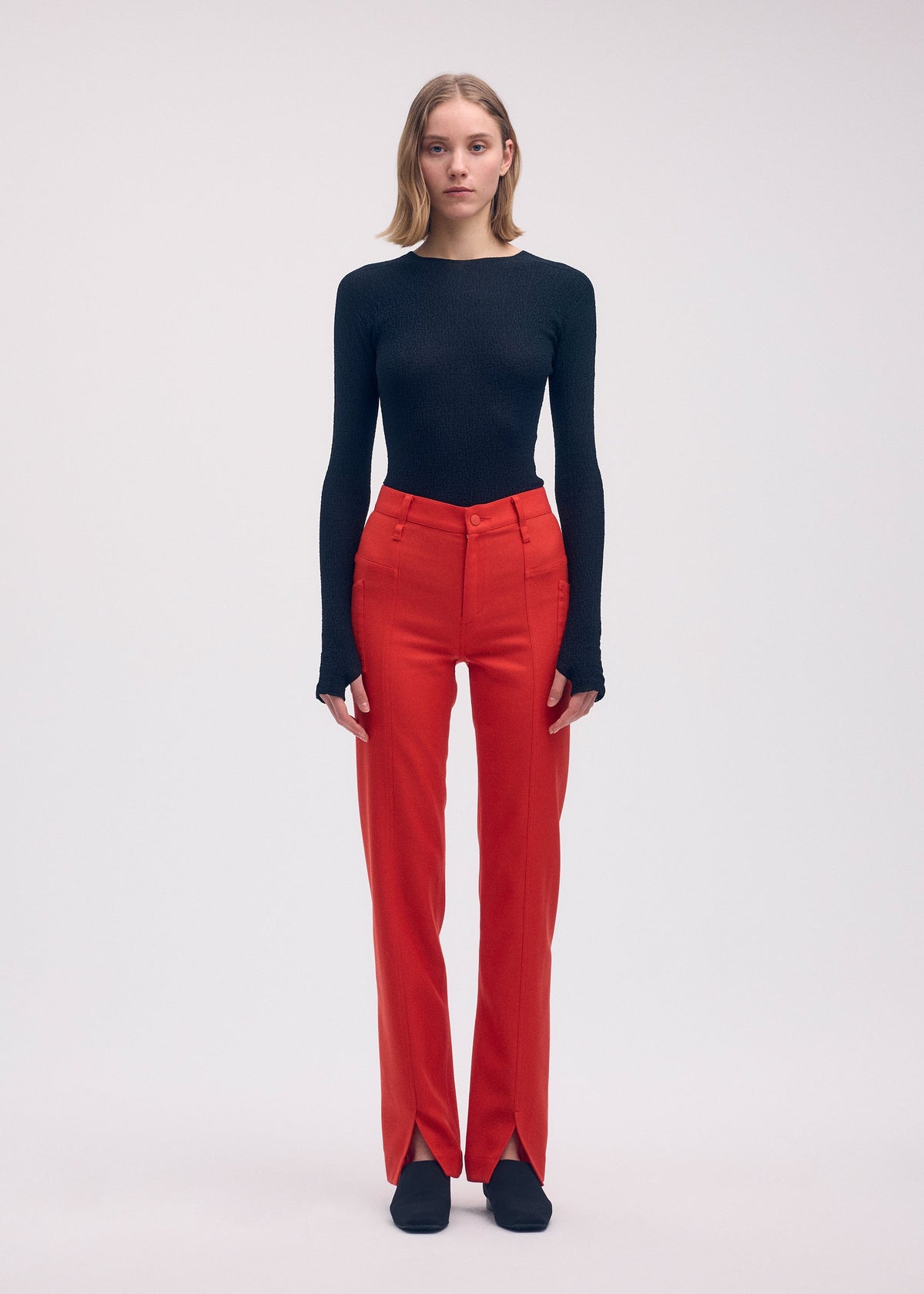 A model wears the ISSEY MIYAKE DISPOCKET PANTS trousers.