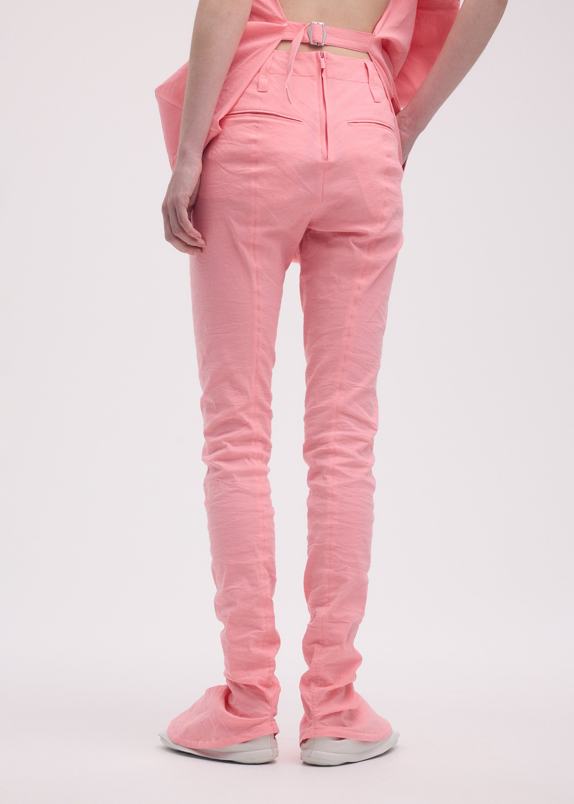 A model wears the ISSEY MIYAKE PAPER BAG trousers.