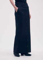 A model wears the ISSEY MIYAKE LIKE TORSO LIKE SHIRT skirt.