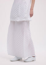 A model wears the ISSEY MIYAKE PAPER BAG PLEATS skirt.