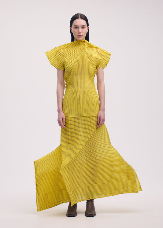 A model wears the ISSEY MIYAKE GENERIC STRIPES (MACHINE PLEATS) clothing.