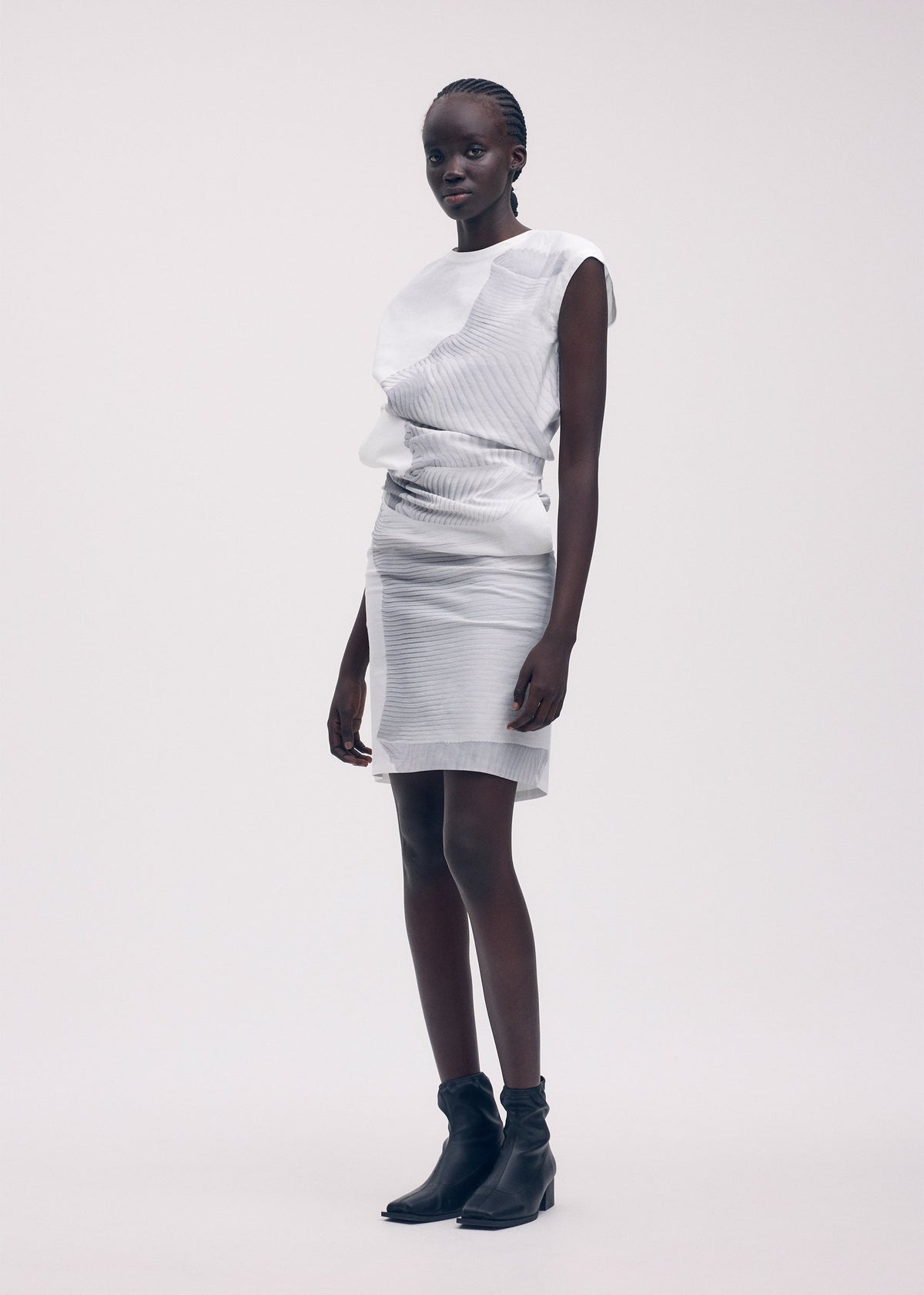 A model wears the ISSEY MIYAKE KNIT (AS REPRESENTED) dress.