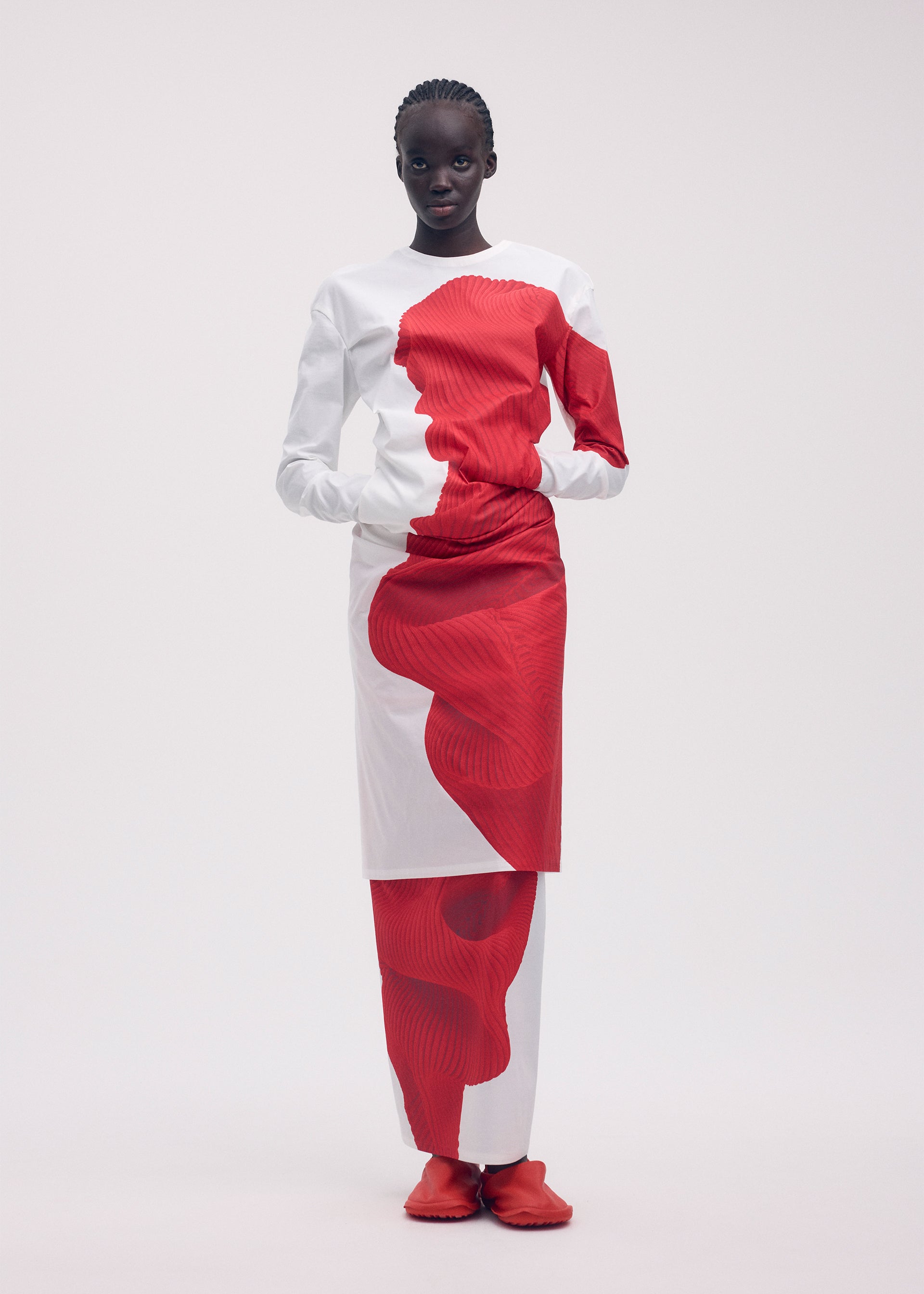 A model wears the ISSEY MIYAKE KNIT (AS REPRESENTED) dress.