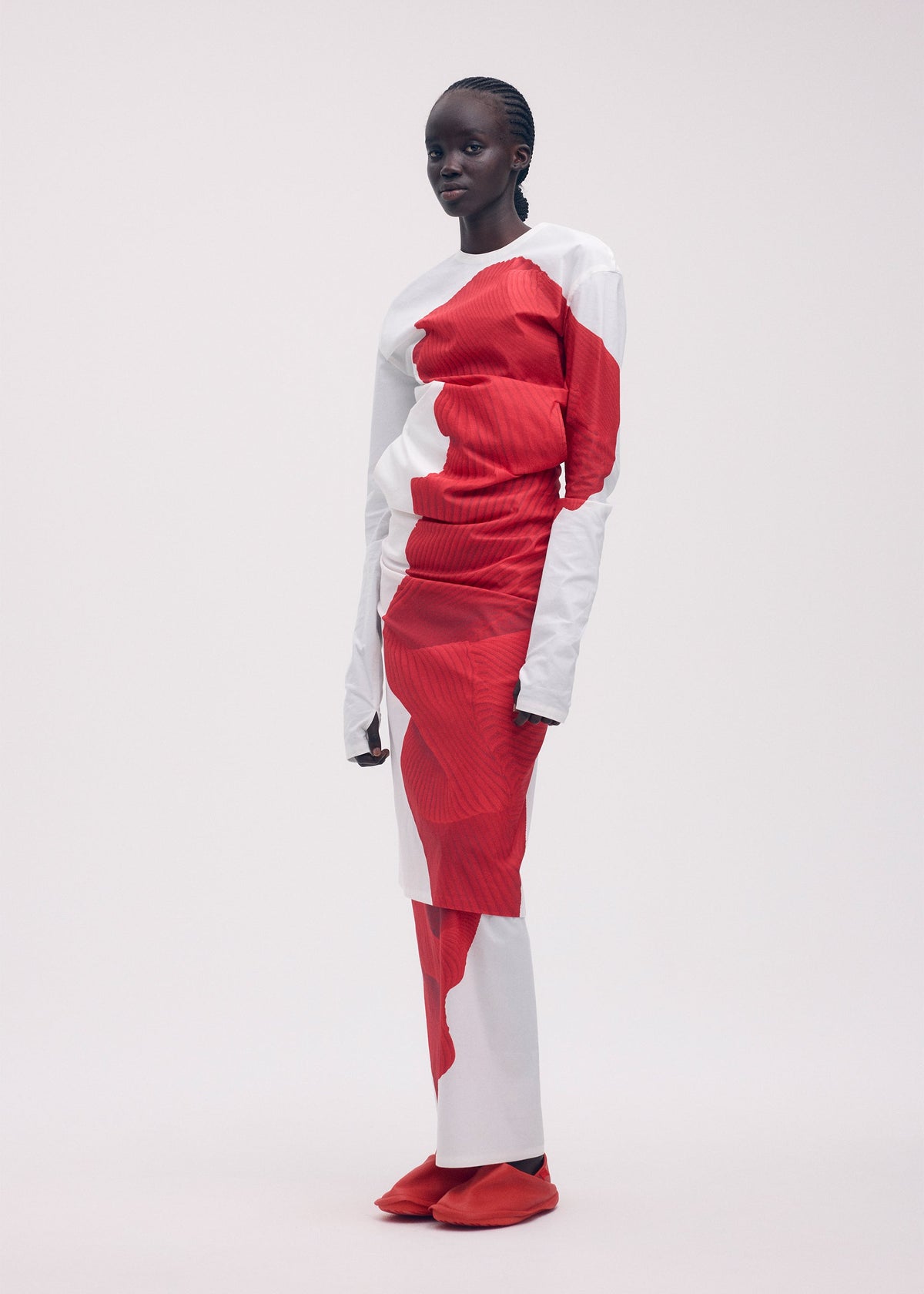 A model wears the ISSEY MIYAKE KNIT (AS REPRESENTED) dress.