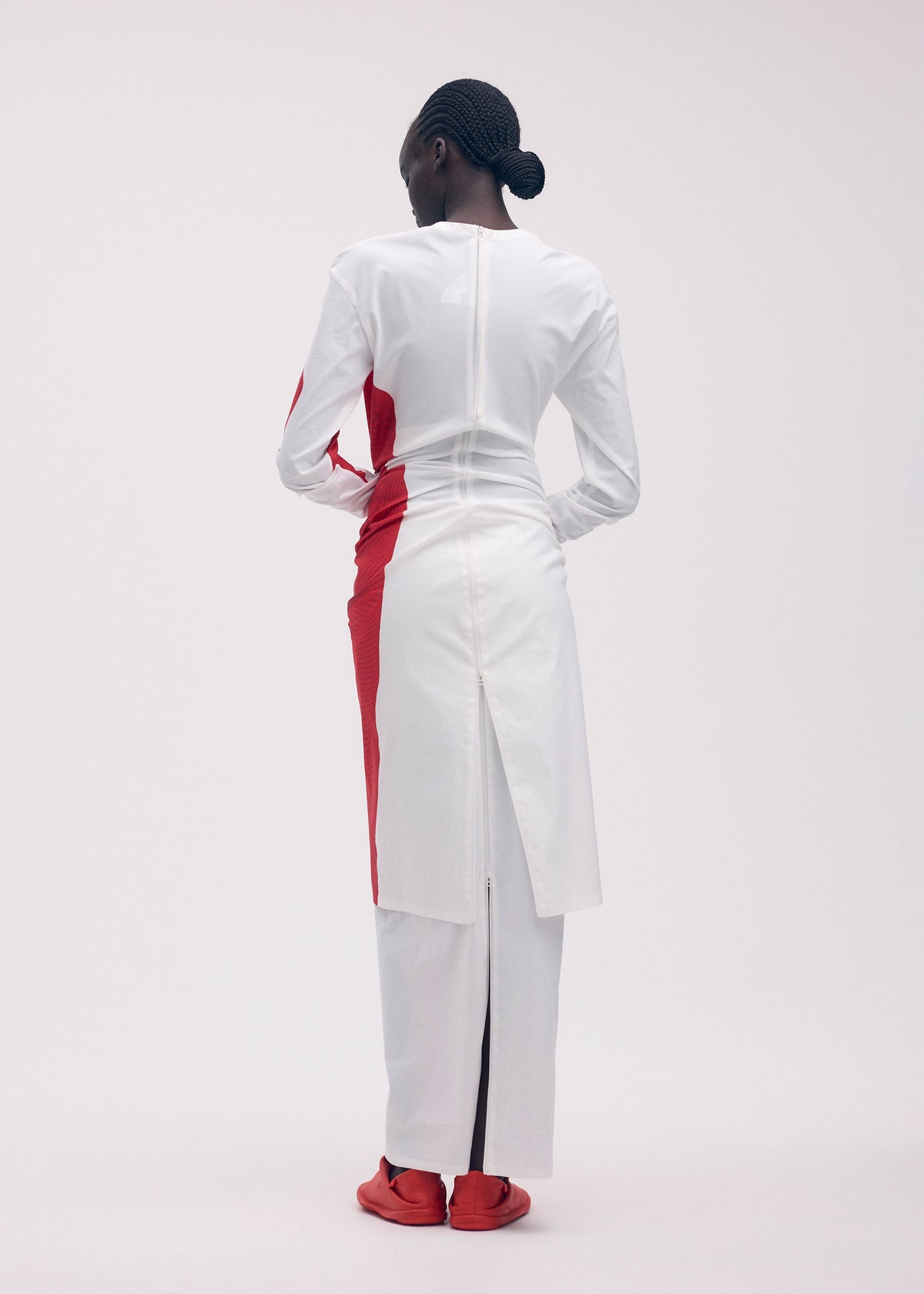 A model wears the ISSEY MIYAKE KNIT (AS REPRESENTED) dress.