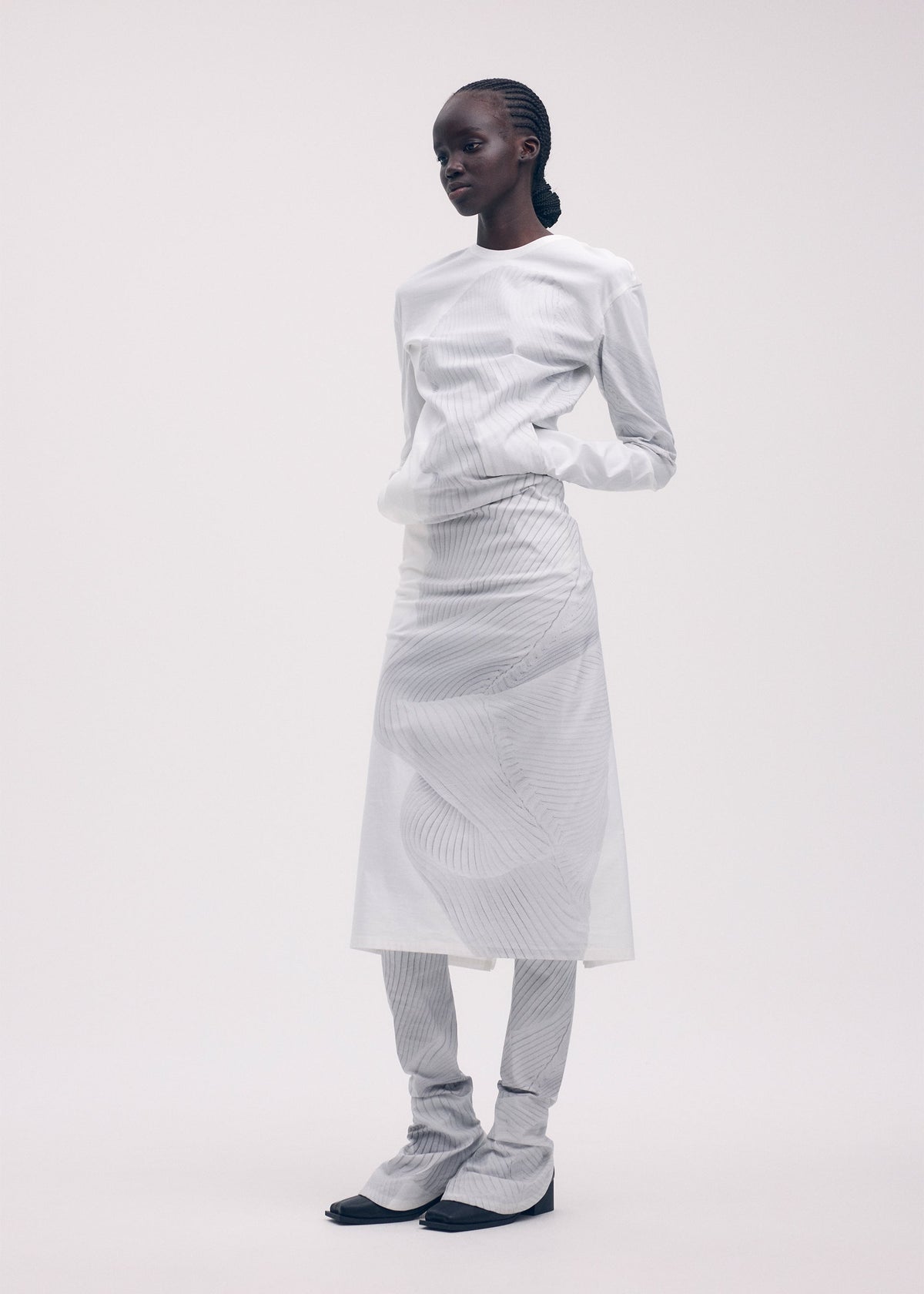 A model wears the ISSEY MIYAKE KNIT (AS REPRESENTED) dress.