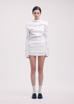 A model wears the ISSEY MIYAKE LIKE TORSO LIKE SHIRT dress.