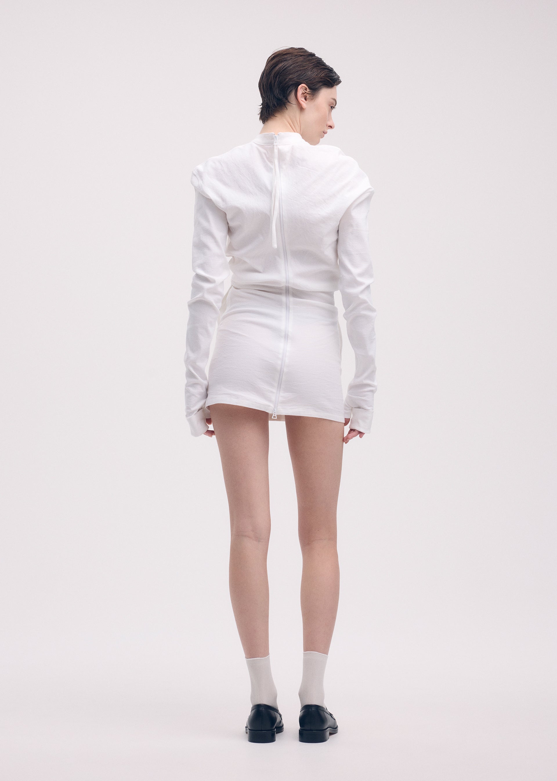 A model wears the ISSEY MIYAKE LIKE TORSO LIKE SHIRT dress.