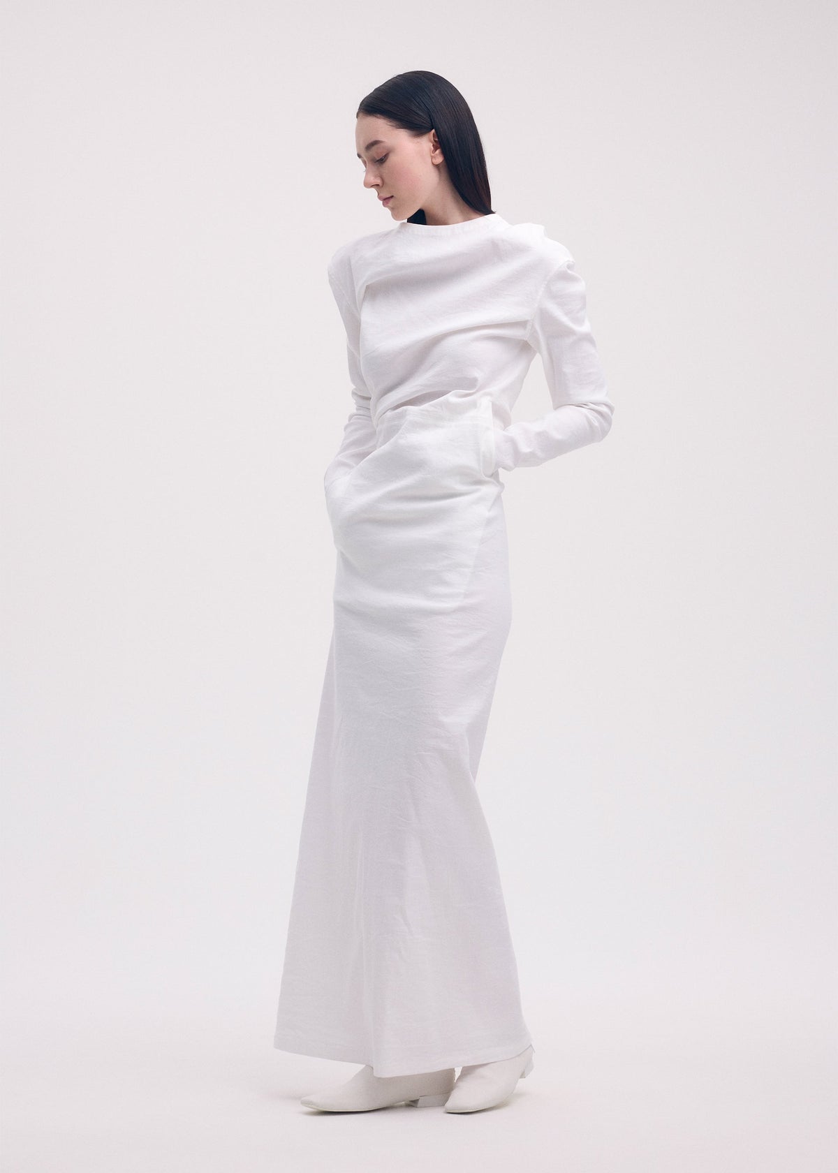 A model wears the ISSEY MIYAKE LIKE TORSO LIKE SHIRT dress.