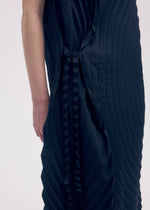 A model wears the ISSEY MIYAKE PAPER BAG PLEATS dress.