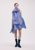 A model wears the ISSEY MIYAKE GENERIC STRIPES (MACHINE PLEATS) clothing.