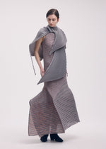 A model wears the ISSEY MIYAKE GENERIC STRIPES (MACHINE PLEATS) clothing.