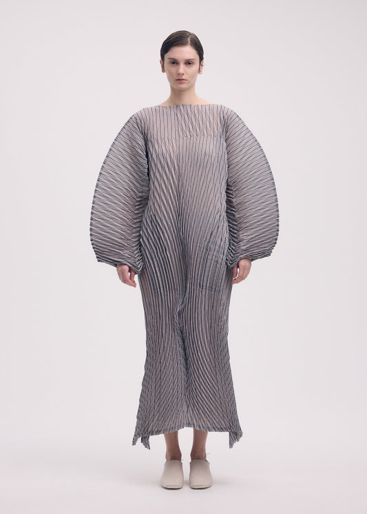 A model wears the ISSEY MIYAKE GENERIC STRIPES (HAND PLEATS) clothing.