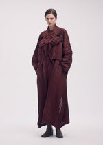 A model wears the ISSEY MIYAKE WAVE PLEATS dress.