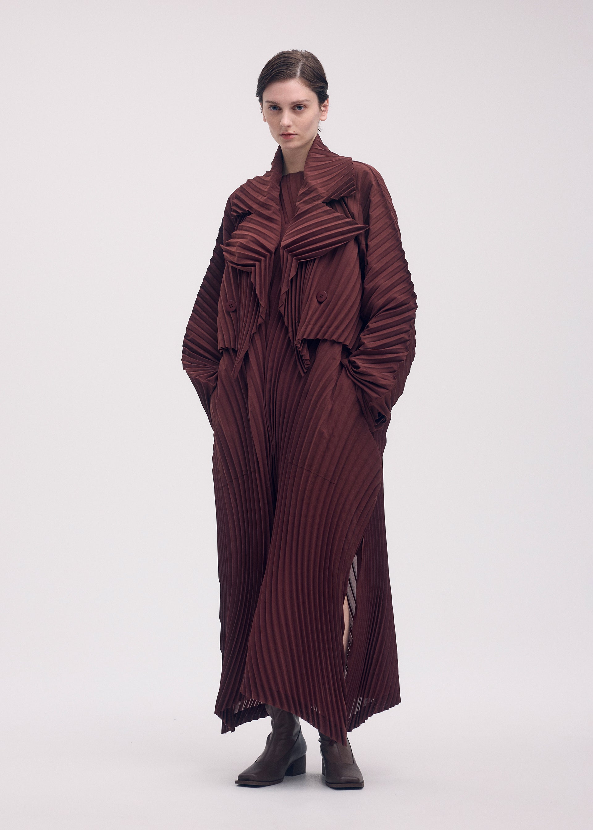 A model wears the ISSEY MIYAKE WAVE PLEATS dress.