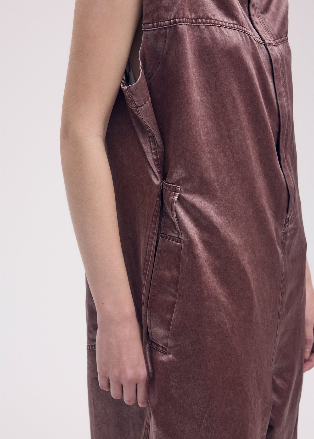 A model wears the ISSEY MIYAKE PSEUDO JEANS jumpsuit.