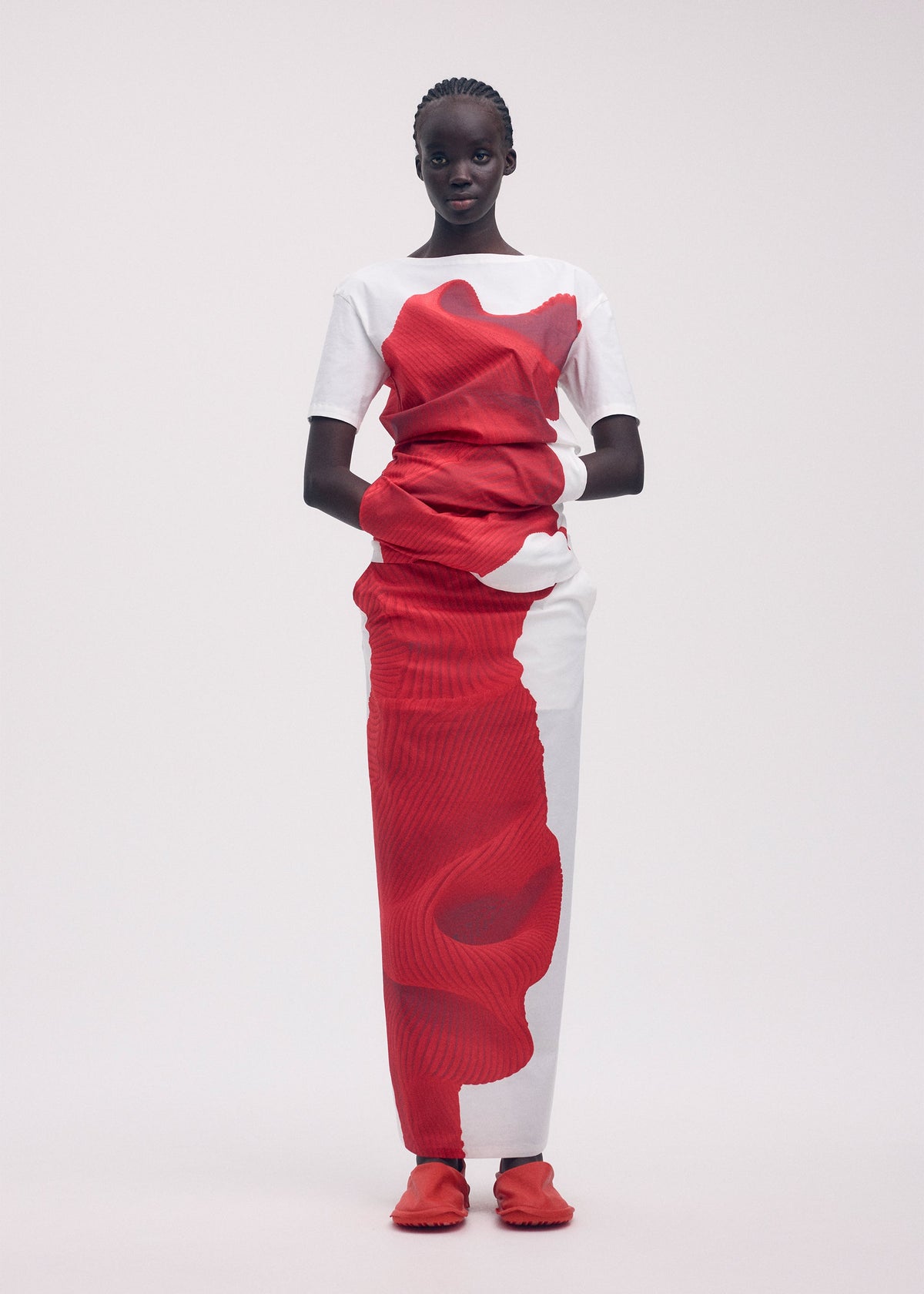 A model wears the ISSEY MIYAKE KNIT (AS REPRESENTED) shirt.