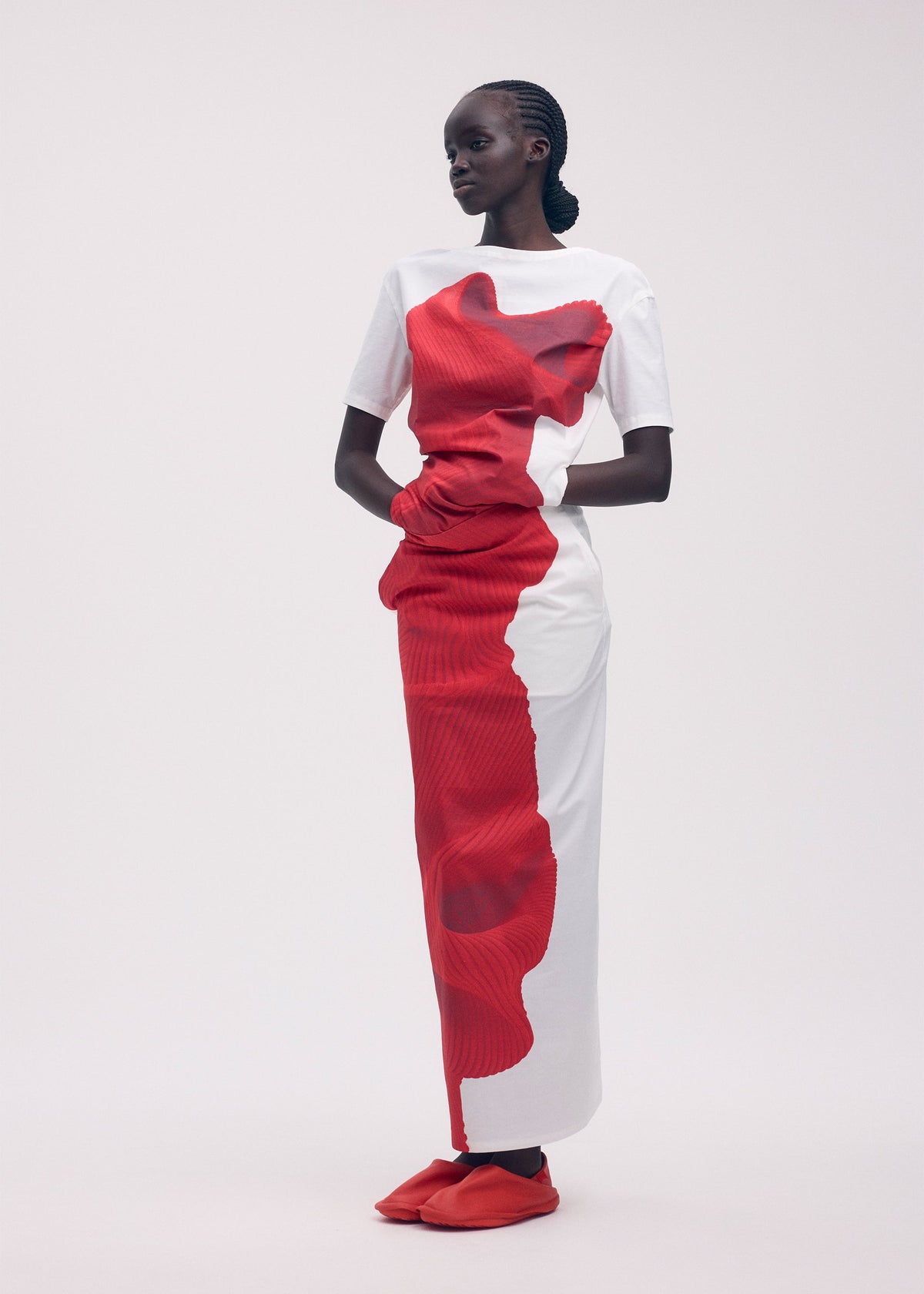 A model wears the ISSEY MIYAKE KNIT (AS REPRESENTED) shirt.