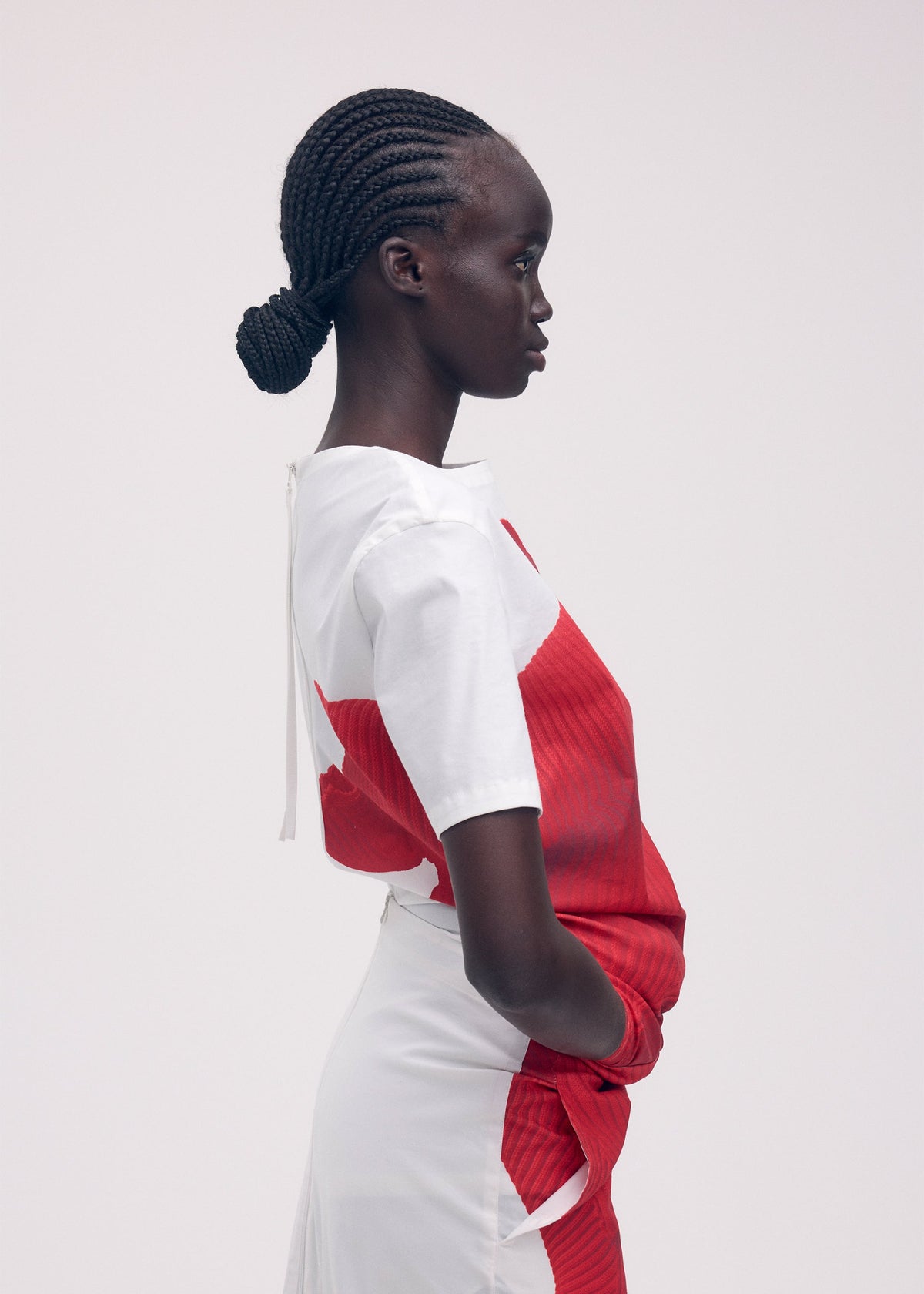 A model wears the ISSEY MIYAKE KNIT (AS REPRESENTED) shirt.