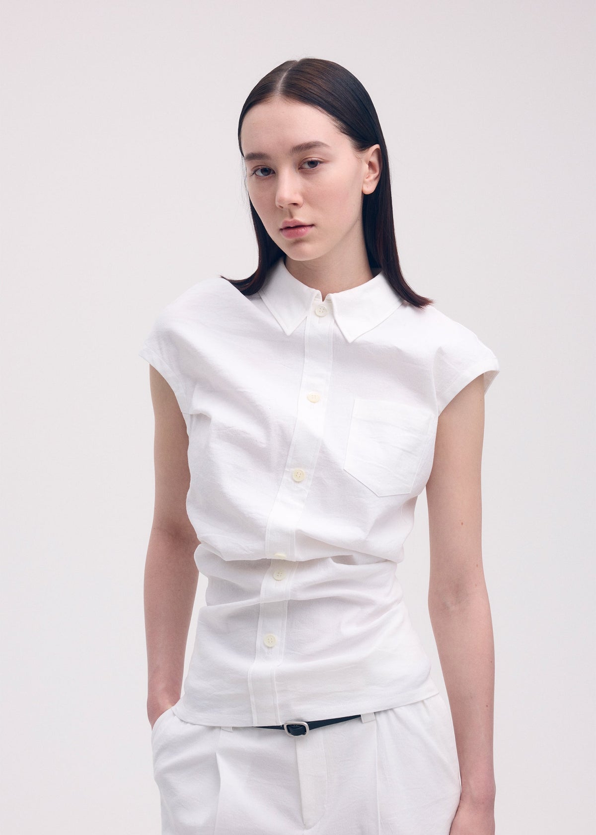 A model wears the ISSEY MIYAKE LIKE TORSO LIKE SHIRT shirt.