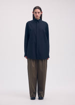 A model wears the ISSEY MIYAKE ODD SHIRT shirt.